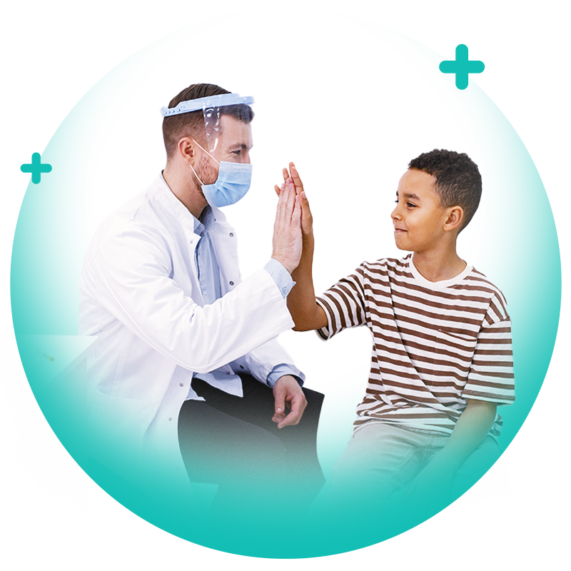 Paediatric healthcare clinician high-fiving a young patient during a supportive clinic consultation.