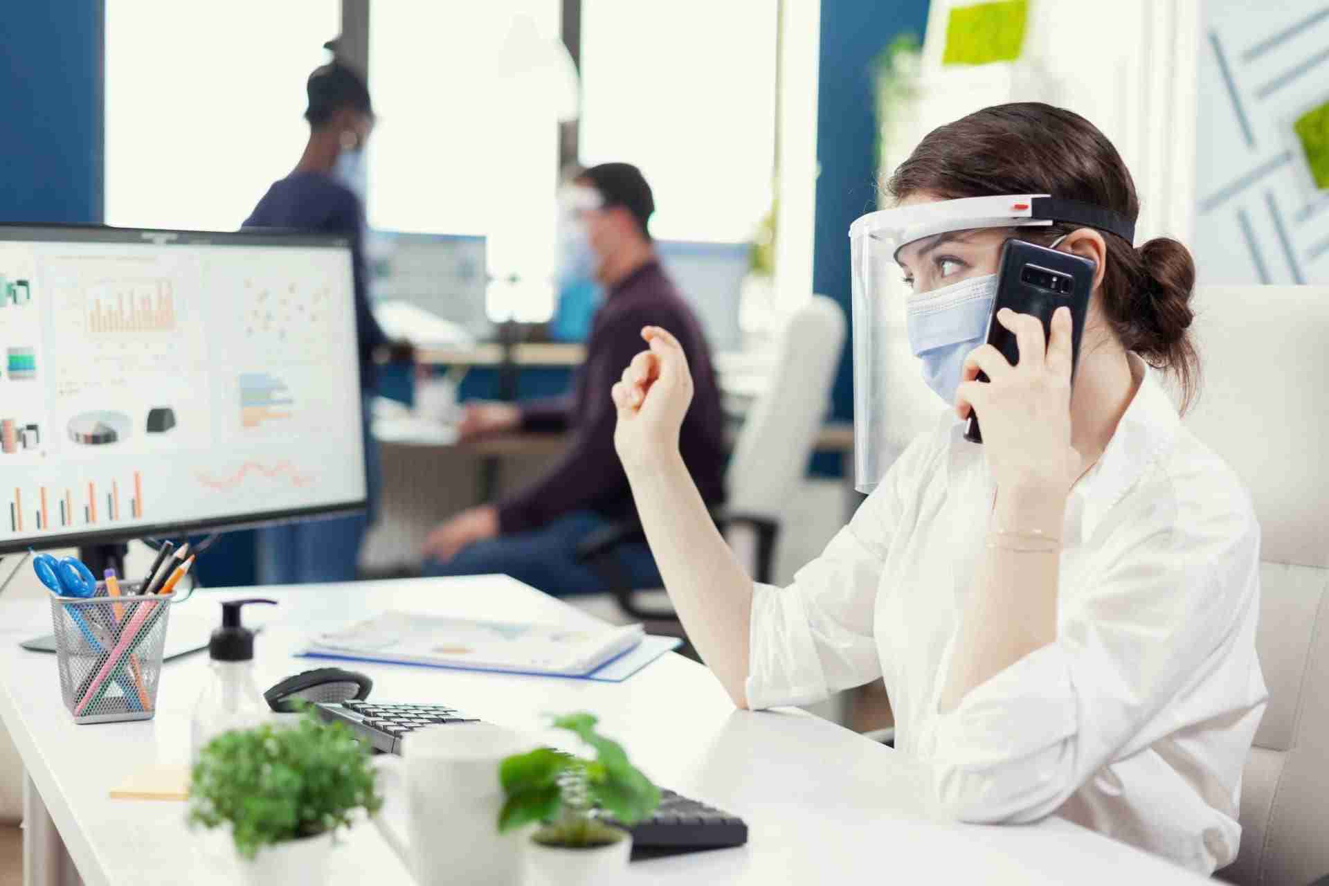 Medical receptionist managing patient enquiries for vision correction clinic marketing